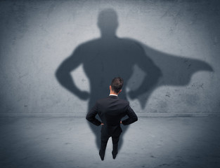 Successful businessman with superhero shadow