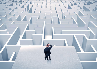 Businessman staring at infinite maze
