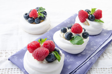 Homemade pavlova meringue cake with fresh berries and whipped cream. Morning. Dessert.