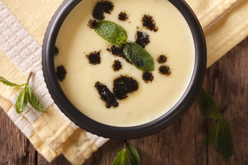 Turkish Yayla soup with rice, mint and yoghurt close-up. horizontal top view
