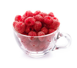 Raspberry in glass cup isolated on white background.