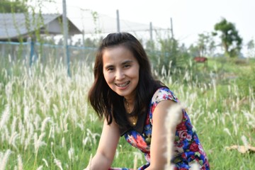 women smile in the farm and grass flower