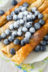 pancakes with blueberries on wooden surface