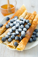 pancakes with blueberries on wooden surface