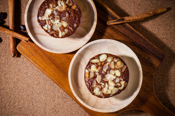 Homemade delicious fresh chocolate and almonds cake on wooden ta