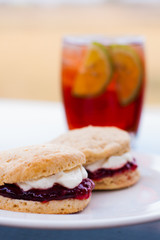 Scones with cream and jam and ice tea