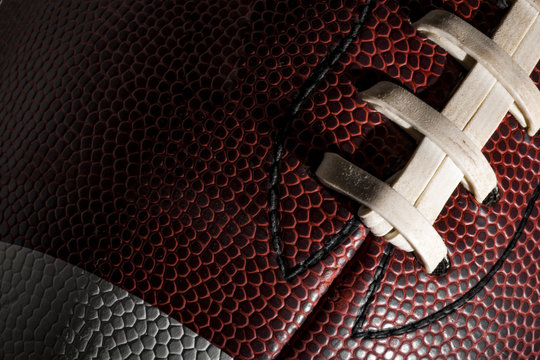 Macro of a american football ball with visible laces, stitches and pigskin pattern