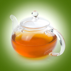 Teapot glass with tea isolated on a beige background with clipping path. Front view.