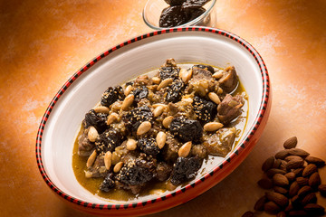 tajine with meat plum almond and sesame seeds