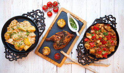 Overhead view of colorful roast vegetables, savory sauces served