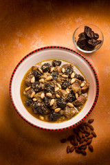tajine with meat plum almond and sesame seeds