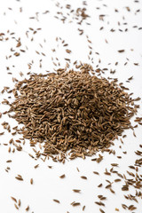 caraway seeds on white table