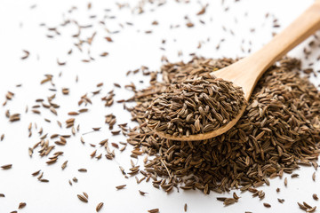 caraway seeds on white table