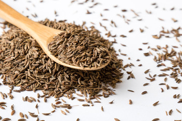 caraway seeds on white table