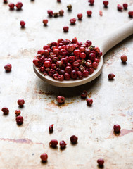 red peppercorn seeds on steel plate