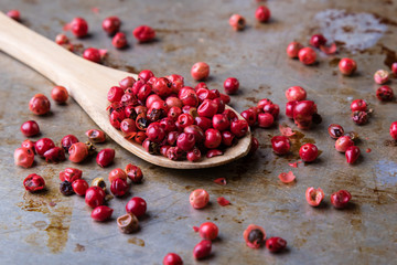 red peppercorn seeds on steel plate