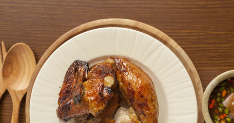Closeup have plate of grill chicken with spicy sauce Thai style