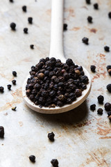 black peppercorn seeds on steel plate