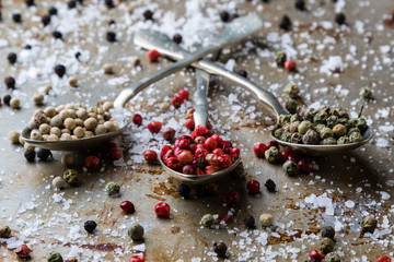 peppercorn seeds on vintage spoons