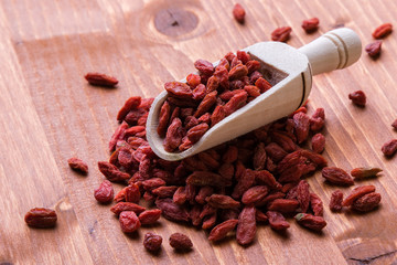 dried goji on wooden table