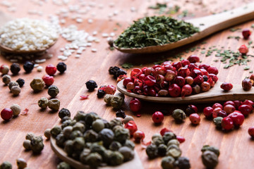 colorful spices in wooden spoons