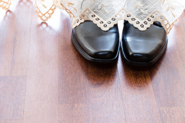 black shoes behind curtain