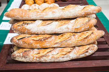 Loaf of homemade bread on wooden plate