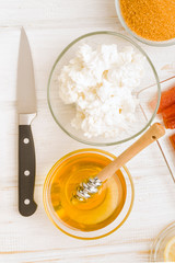 Vertical making bowl of cottage cheese with honey