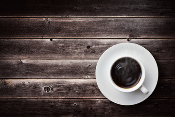 a cup of coffee on vintage wooden table
