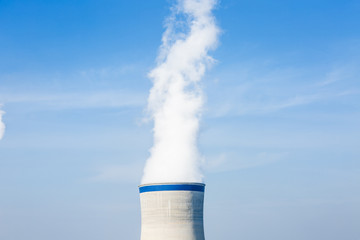 Industrial power plant smoke pollution in the blue sky