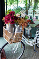 Fototapeta na wymiar Basket with flowers on vitage city bicycle