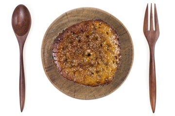 Banana cake with wooder spoon on white background.