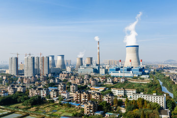 Fototapeta na wymiar Industrial power plant smoke pollution in urban suburb