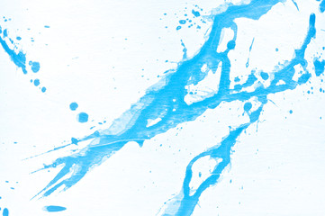 Blue watercolor background. Acrylic hand painted splash isolated on white background. Abstract acrylic paint splatter. Fashion and beauty. Indigo tone. Close up.
