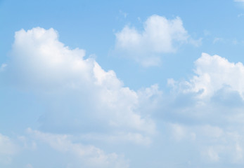 blue sky background  is covered by white clouds , and space for add text above .
( clouds looked shape Imagination idea image)