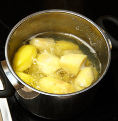 Potatoes boiling in saucepan