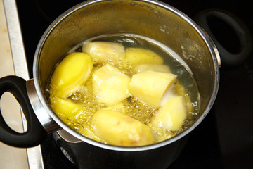 Potatoes boiling in saucepan