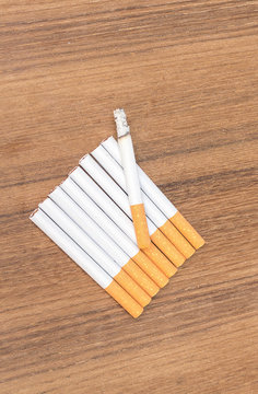 Tobacco  cigarette detrimental on wood background ,select focus front
