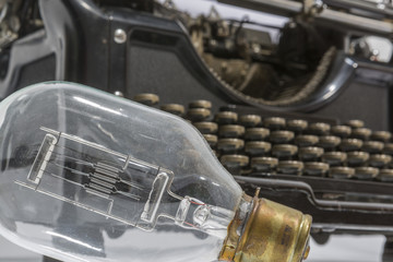 an antique typewriter with a light bulb