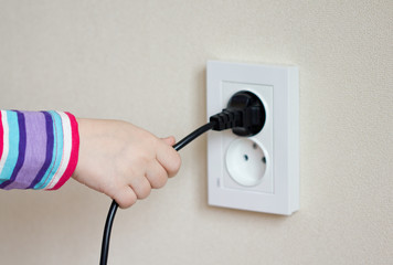 child's hand to pull an electric cord from the outlet