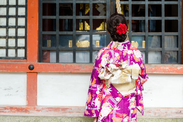 Fototapeta premium Back view of woman ring the bell