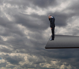 Businessman standing on edge board