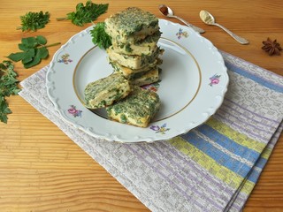 Tofu in green goutweed tempura on plate, cooking organic food with wild plants