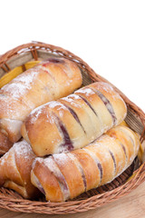 Homemade sweet baked rolls in the wooden basket