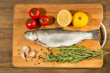 raw trout on rustic wooden table