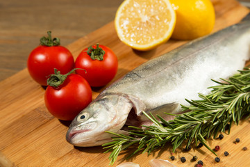 raw trout on rustic wooden table