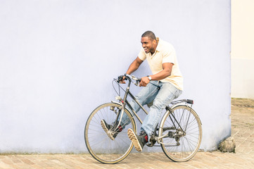 African american guy having fun and good time with vintage bicycle outdoors