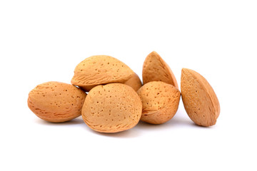 Pile of unpeeled almonds isolated on white background