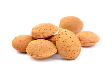 Pile of unpeeled almonds isolated on white background
