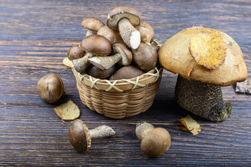 Basket with mushrooms on a wooden background